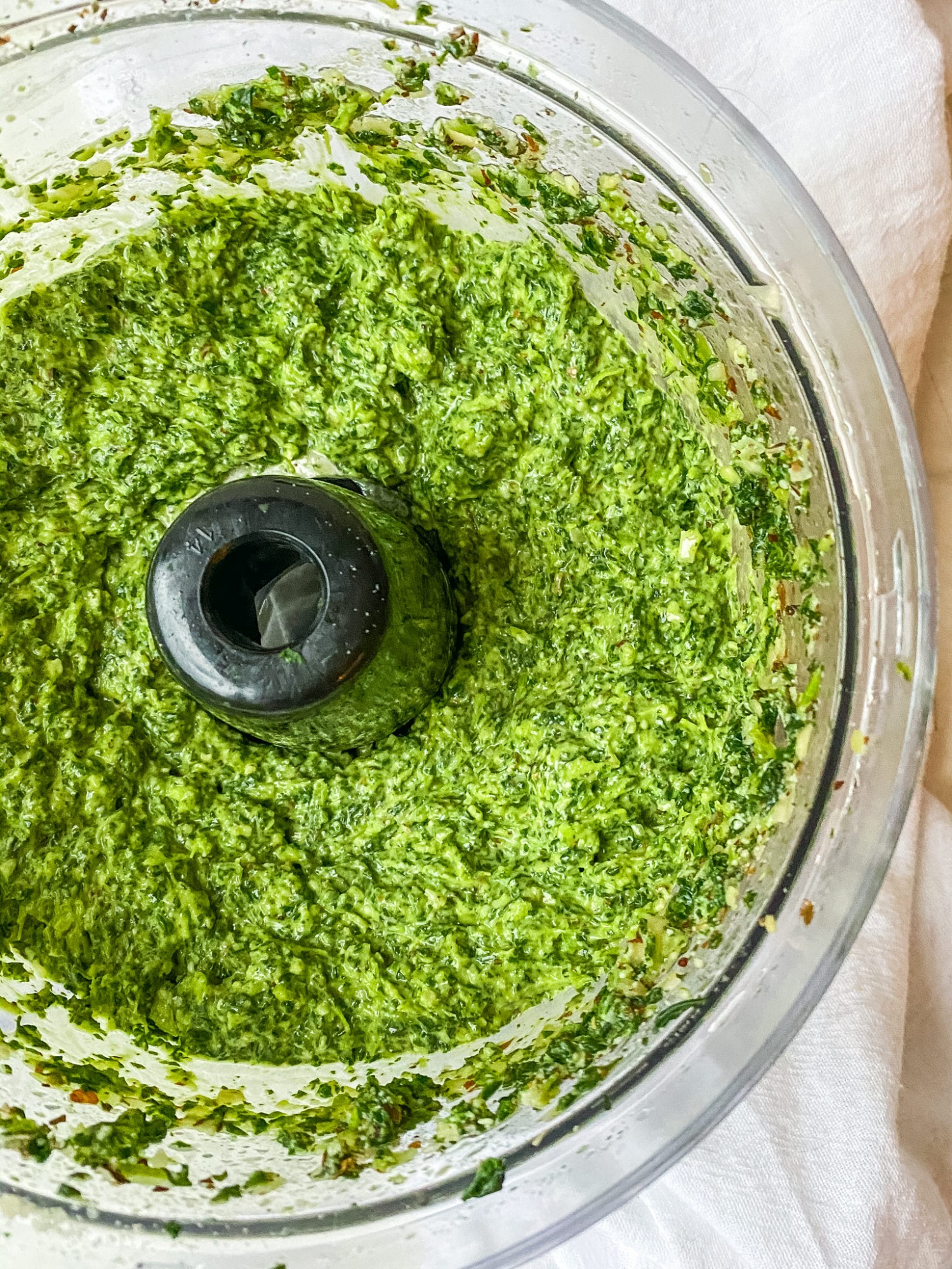 Above view of kale pesto in a food processor