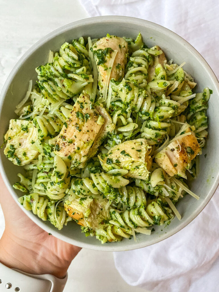 Above view of a bowl of kale pesto pasta with chicken
