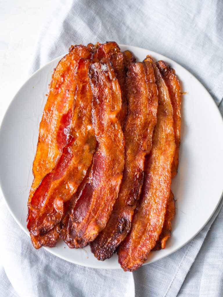 Above view of strips of crispy bacon on a plate