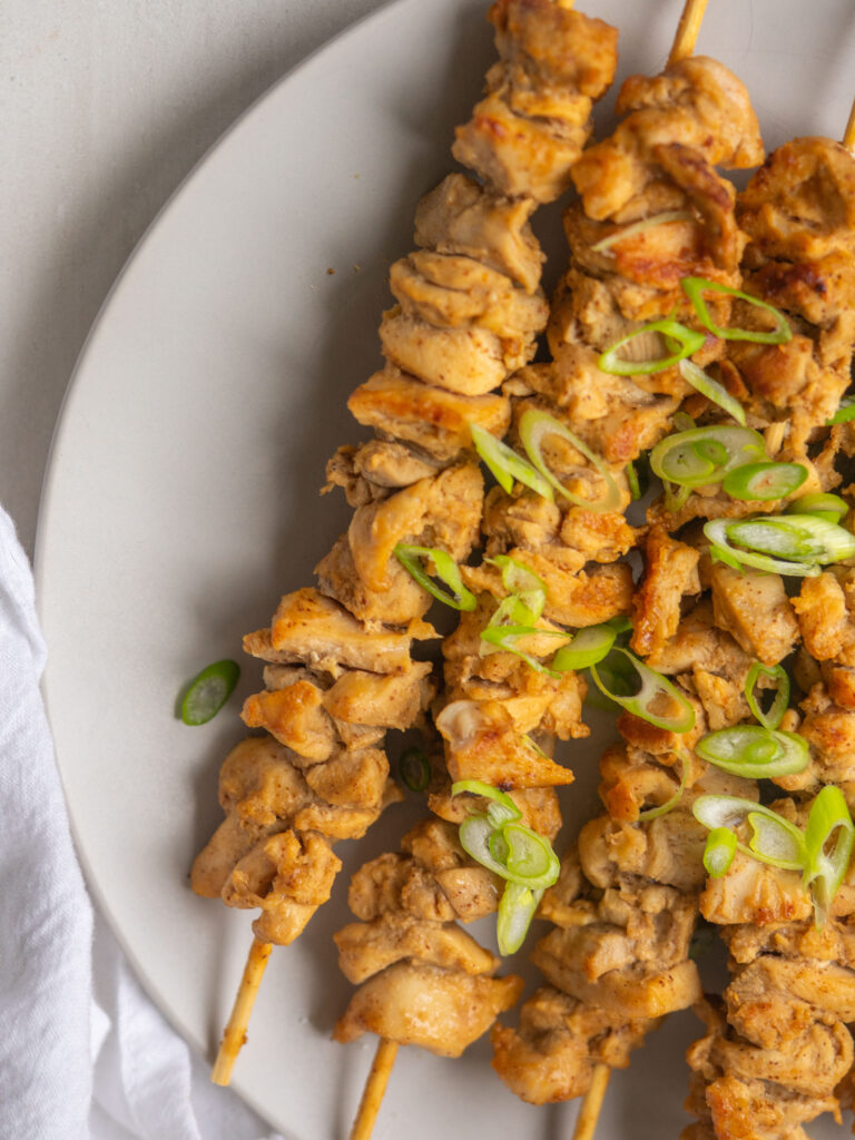 Above view of cooked whole30 chicken satay with green onions on top