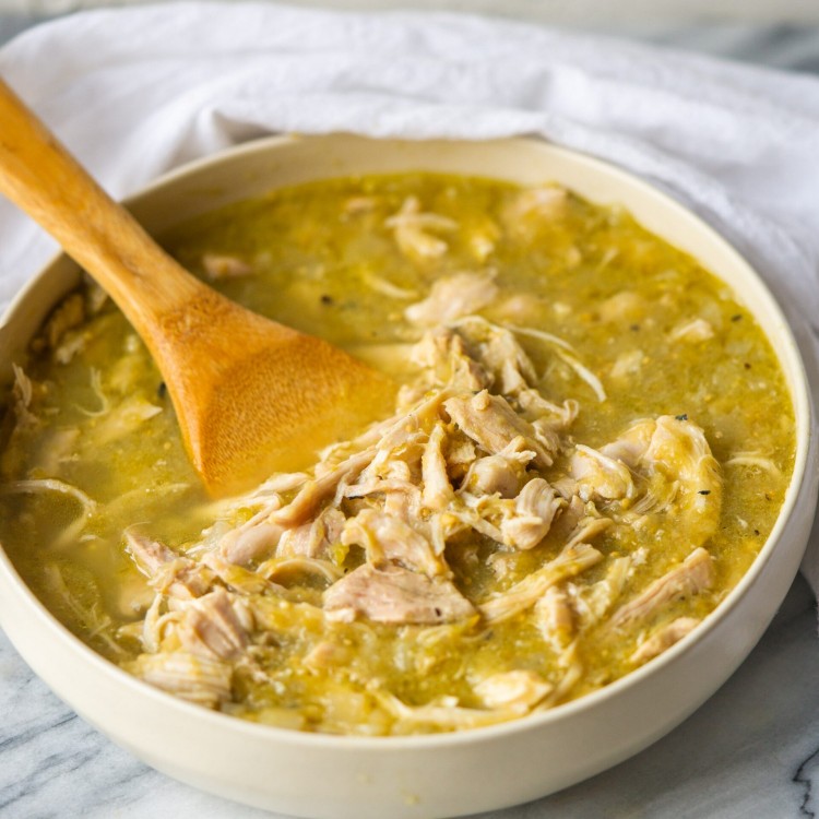 Three quarter view of instant pot salsa verde chicken in a serving bowl