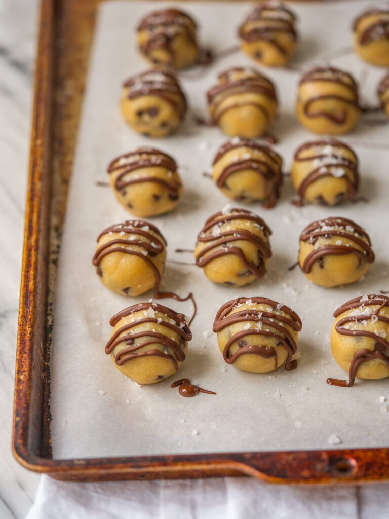 three quarter view of a sheet pan of healthy cookie dough bites