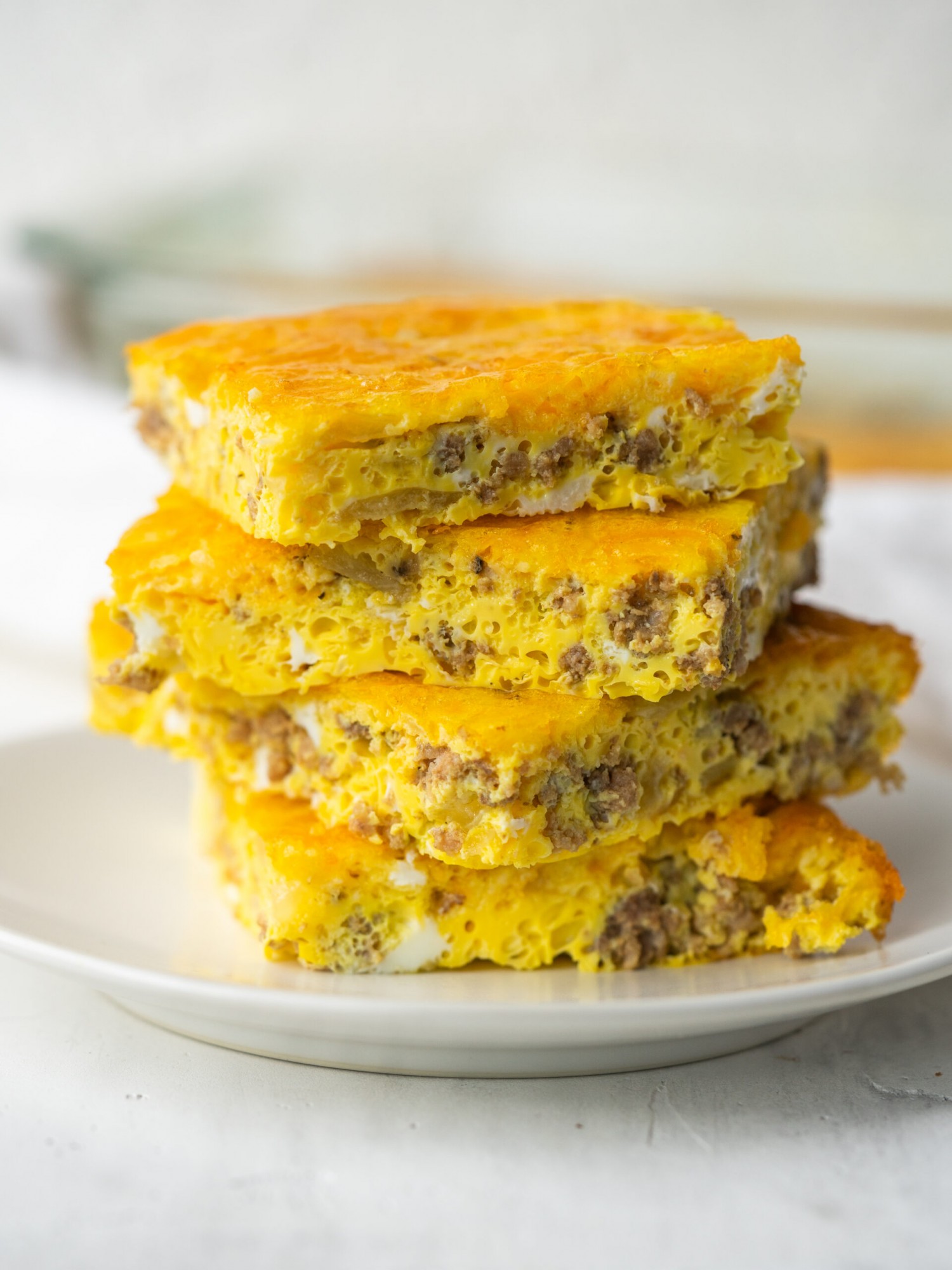 Side view of slices of cheese burger breakfast casserole made with ground beef and eggs