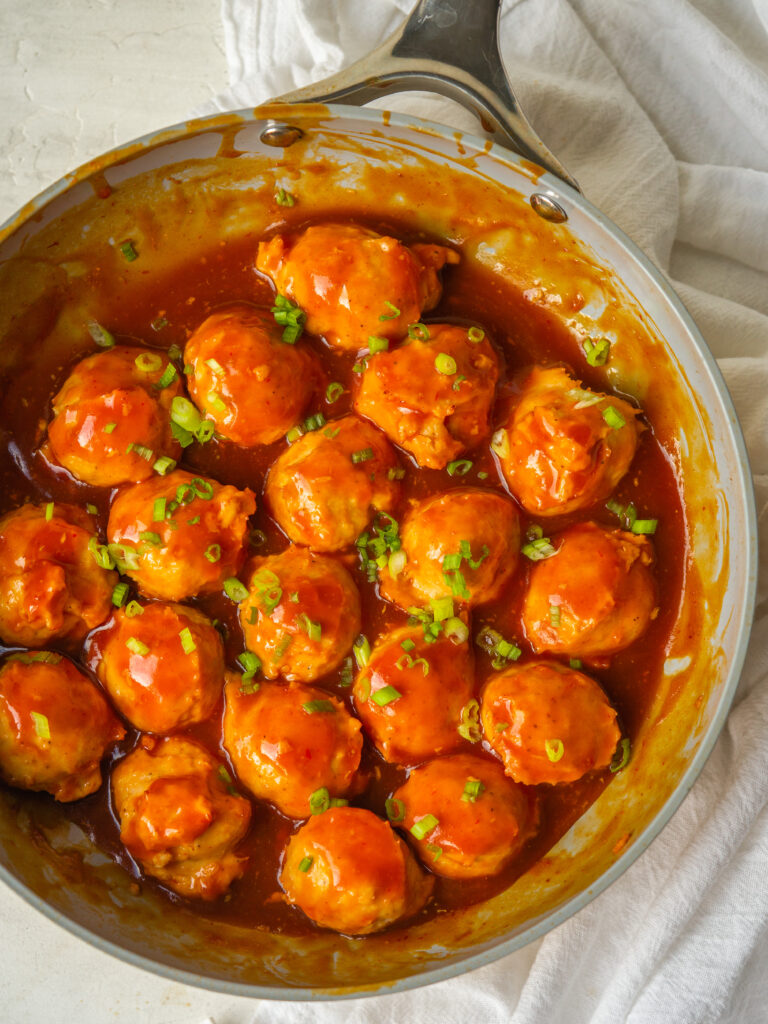 Above view of chicken meatballs in a frying pan