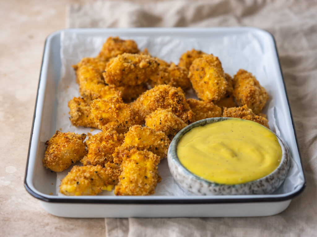 keto chicken nuggets on a tray with honey mustard