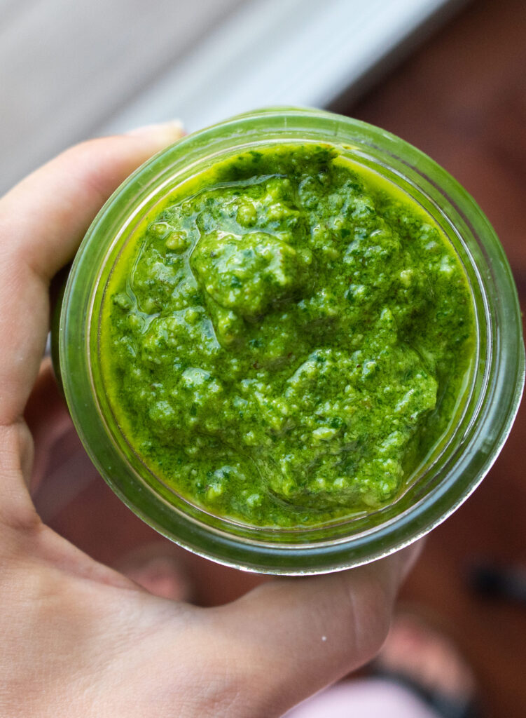 Above view of homemade walnut pesto in a glass jar