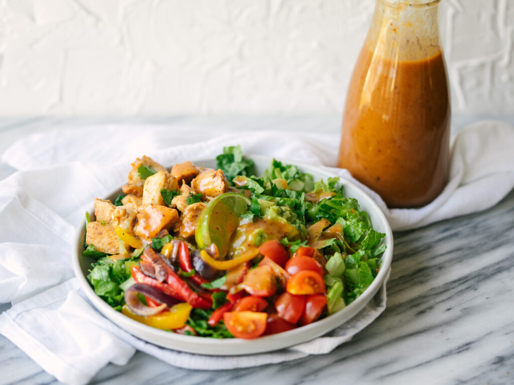Healthy Chipotle salad topped with the honey chipotle vinaigrette