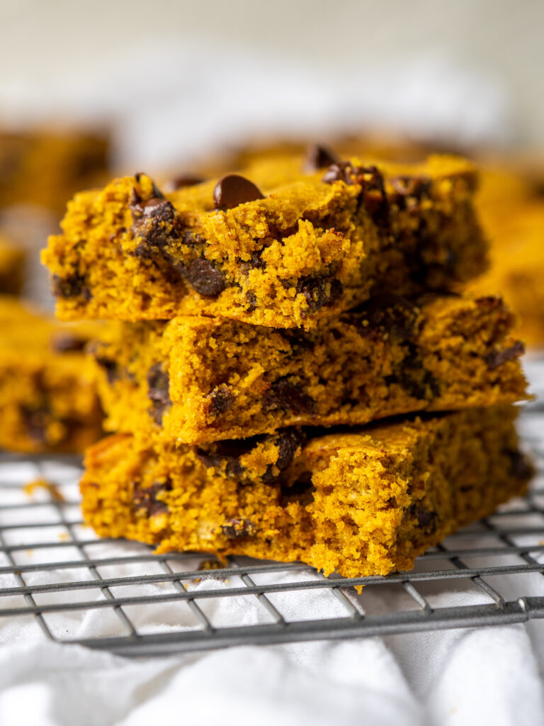 Side view of pumpkin chocolate chip bars cut into sliced and stacked up