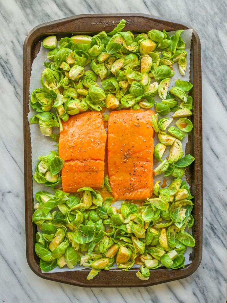 Above view of salmon and brussels sprouts on a sheet pan