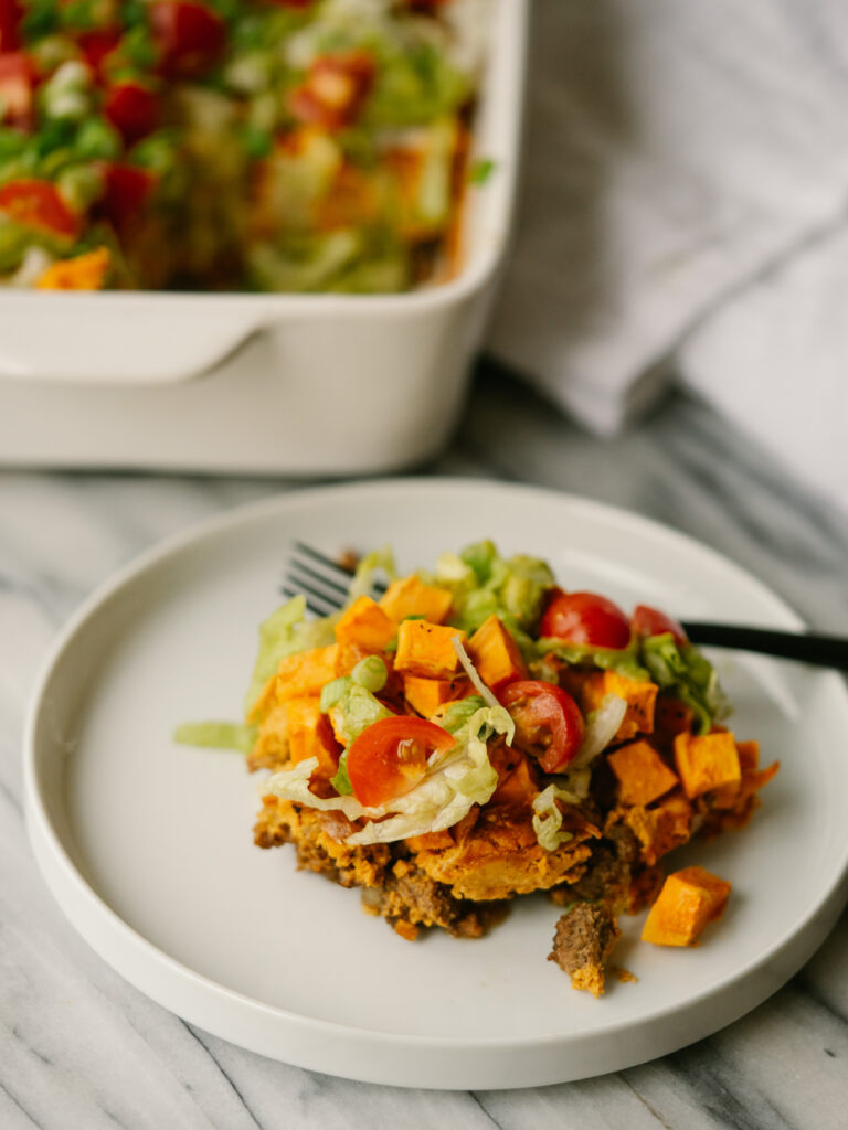 slice of taco casserole with toppings