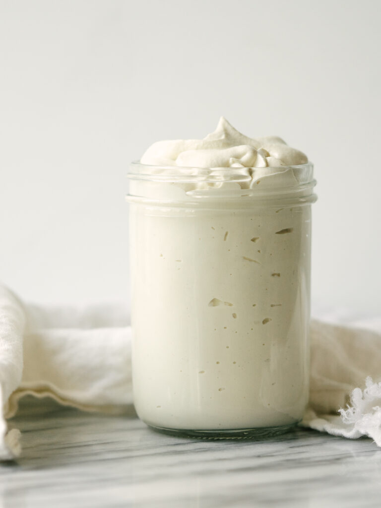 Side view of a jar of cashew sour cream