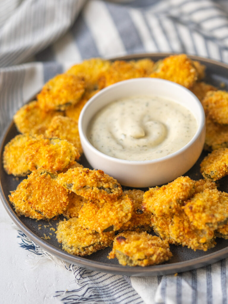 three quarter view of low carb fried pickles on a plate with homemade ranch