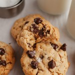 Three quarter view of peanut butter oatmeal chocolate chip cookies on parchment paper