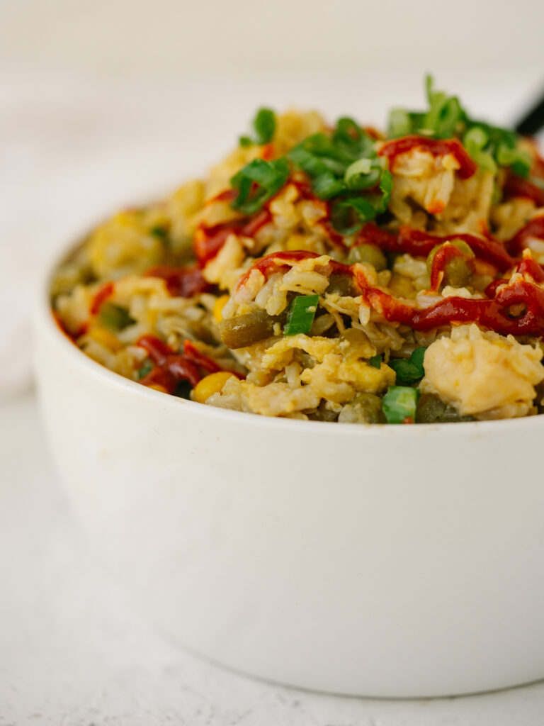 a close up photo of pantry fried rice in a white bowl