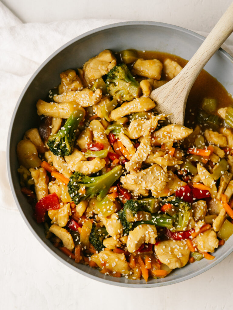 above view of easy chicken and veggie stir fry with a wooden sppon