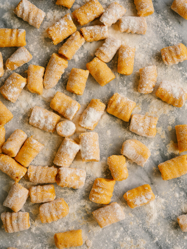 overhead view of uncooked sweet potato gnocchi rolled out and cut 