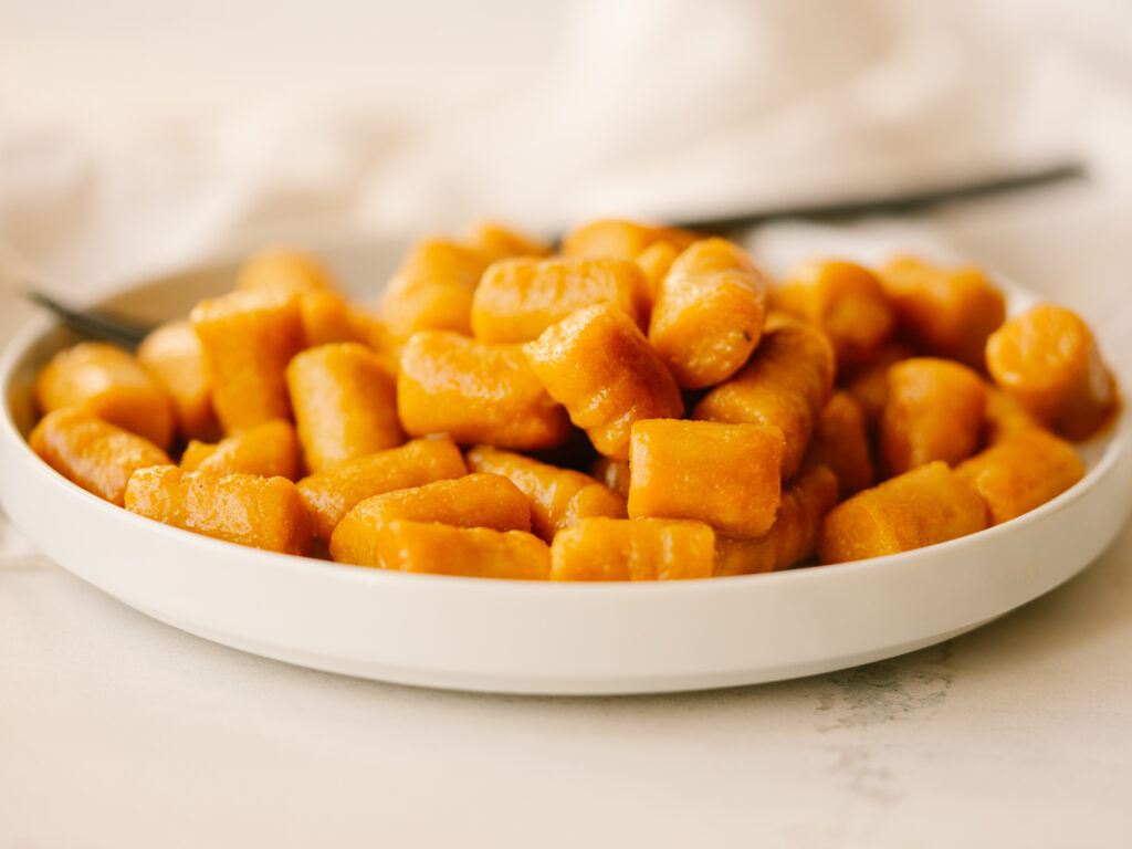 side view of cooked sweet potato gnocchi on a plate
