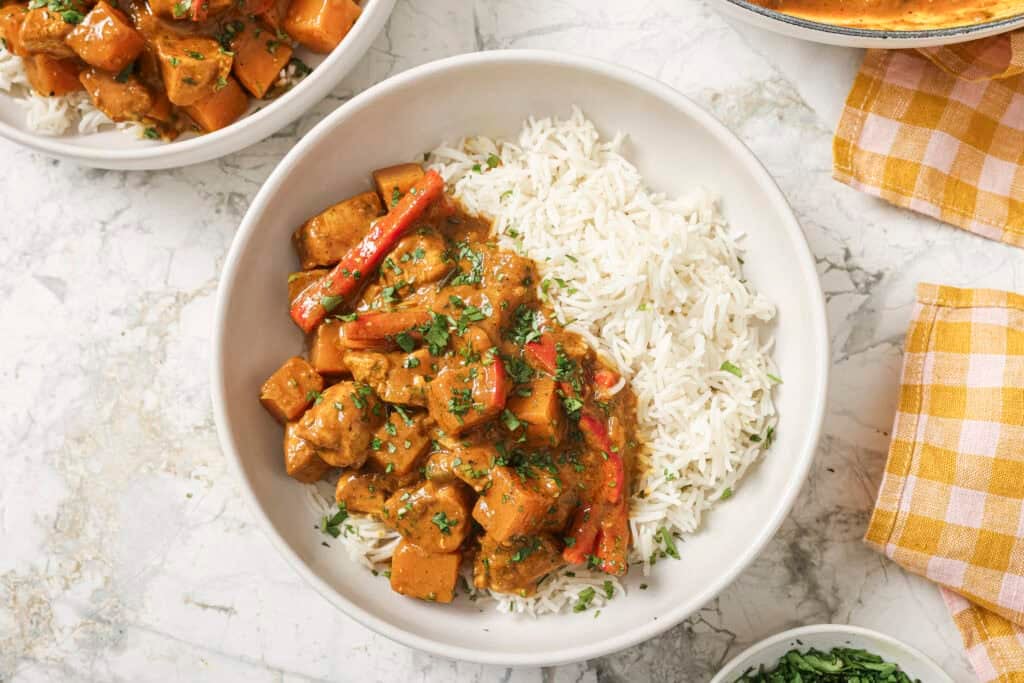 final dish of pumpkin coconut chicken curry on a plate with rice
