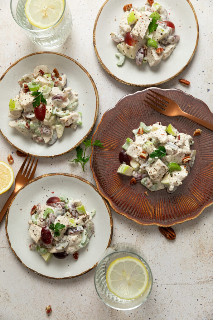 an above view image of waldorf chicken salad servings on four plates