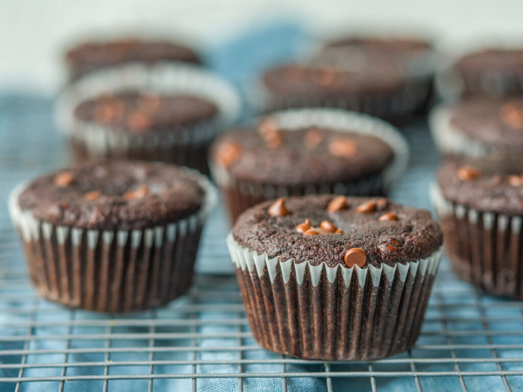 three quarter view of healthy double chocolate muffins on a cooling rack