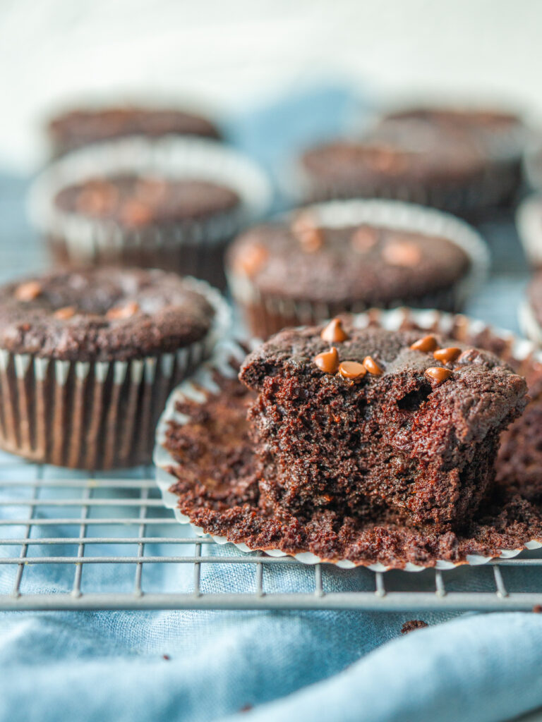 side view of a healthy double chocolate muffin with a bite out of it