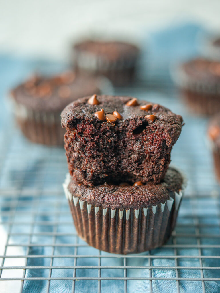 side view of healthy chocolate muffins stacked on  a cooling rack