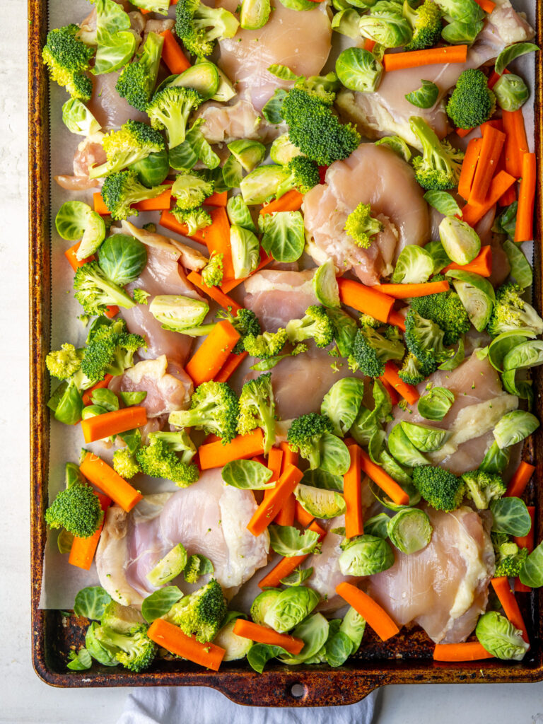 oven baked chicken thighs and veggies from above before cooking