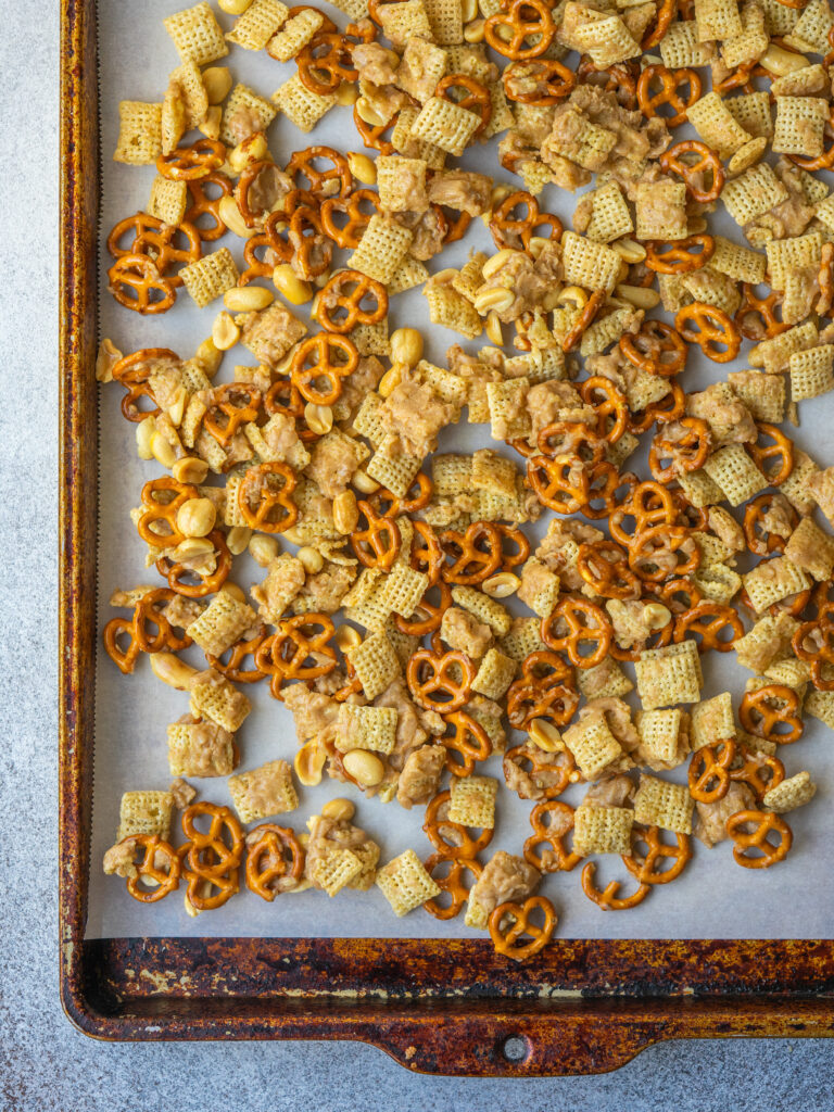 Sweet chex mix recipe on a sheet pan cooling