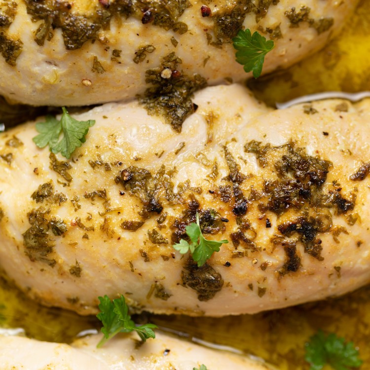 Close up above view of herb chicken in a baking dish