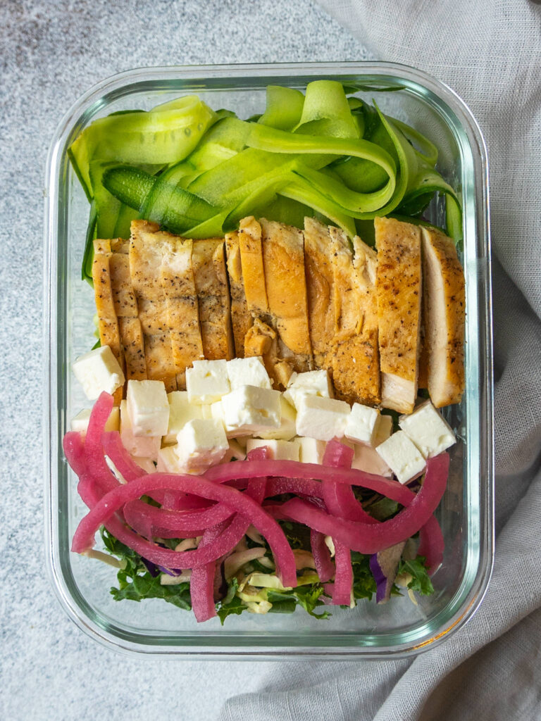 Sliced cooked chicken breast on a salad