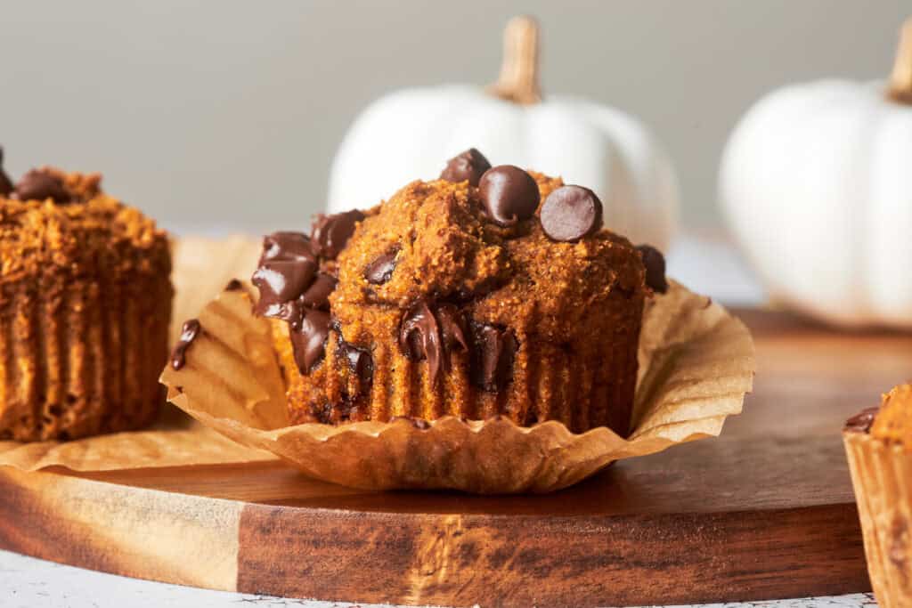 a healthy pumpkin chocolate chip muffin half unwrapped 