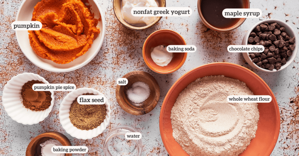 all ingredients for pumpkin chocolate chip muffins in small bowls with ingredient labels on them 