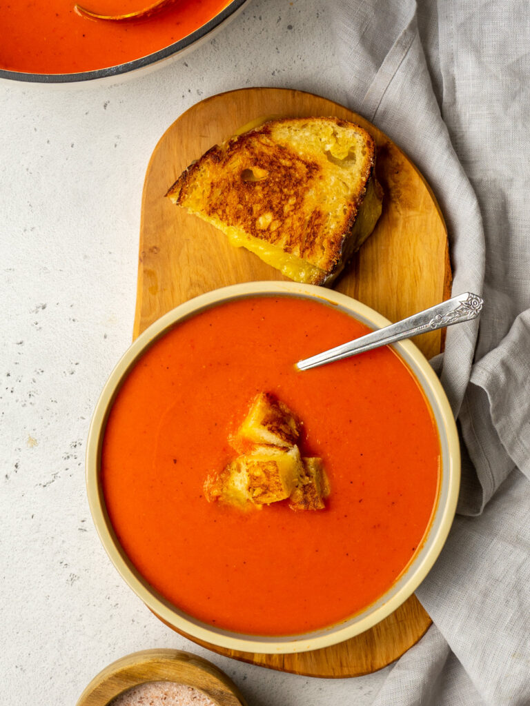 grilled cheese croutons in a bowl of tomato soup