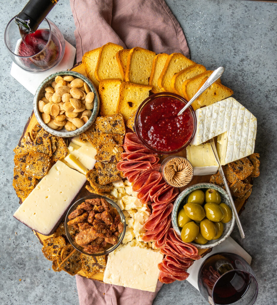 Above view of a trader Joe's charcuterie board with red wine