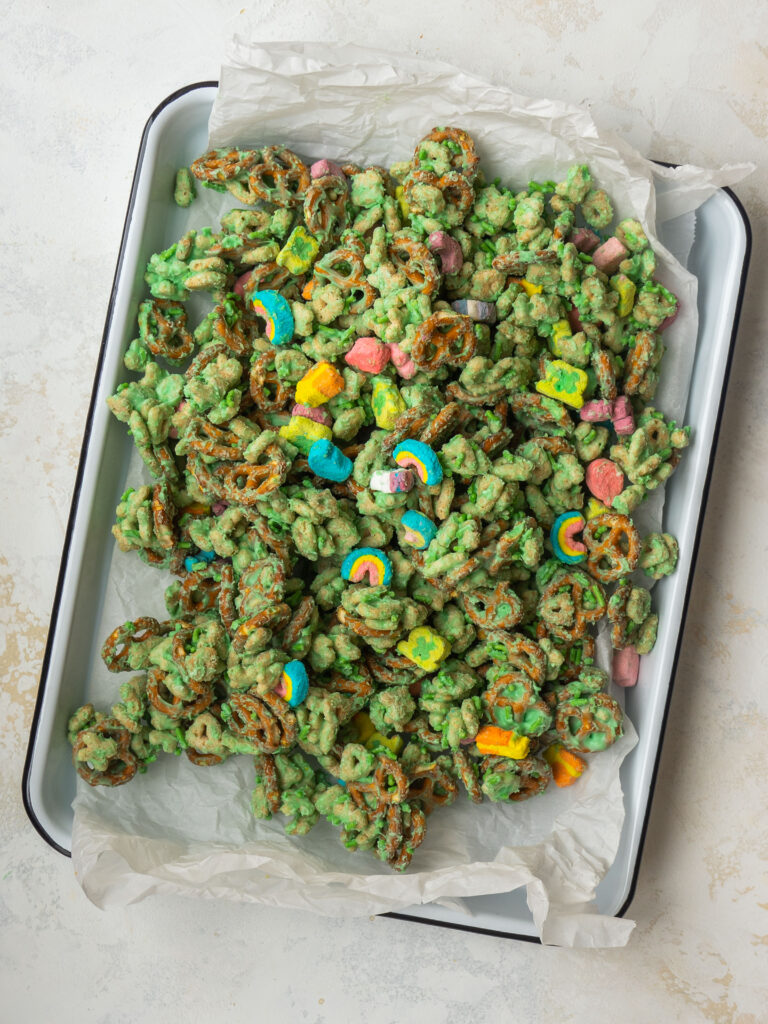 Above view of a green Leprechaun snack mix on a baking sheet with parchment paper