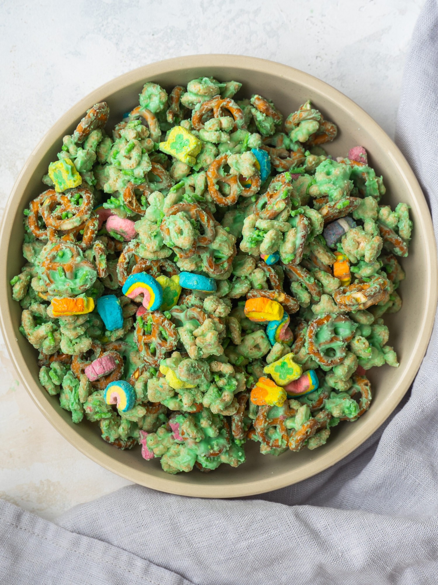 Lucky charms tossed in a green white chocolate in a small serving bowl