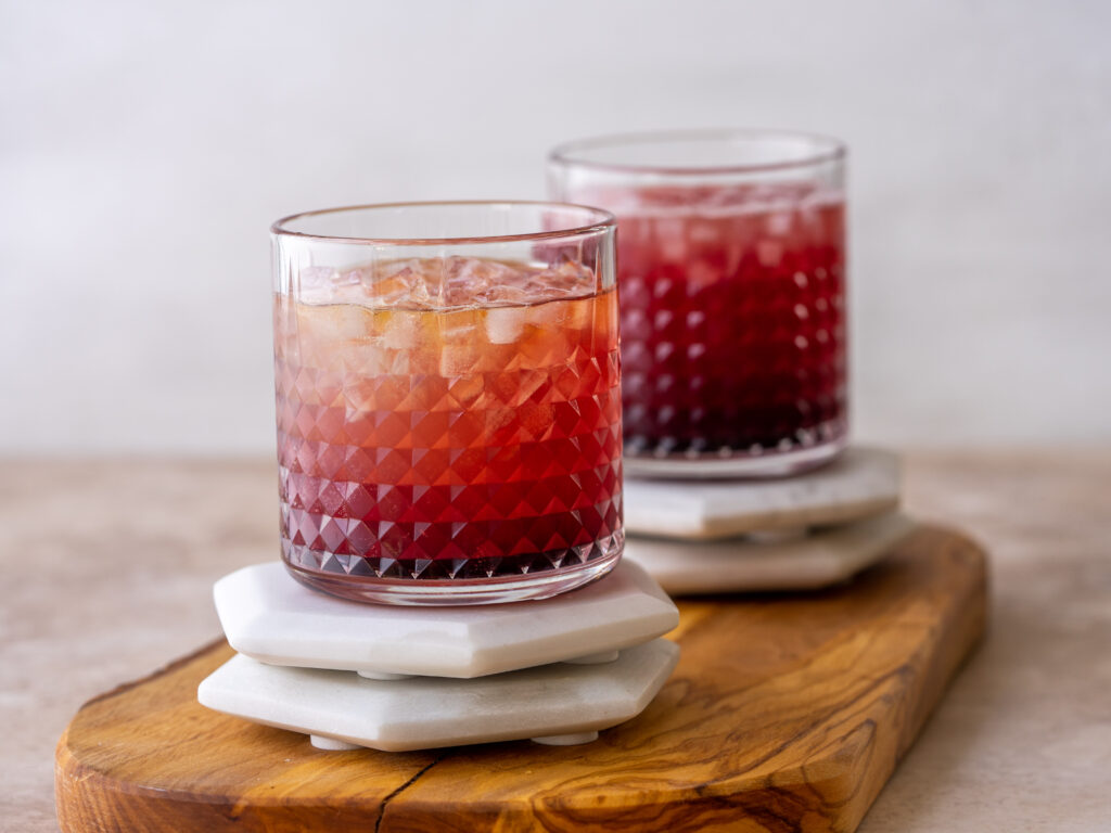 Side view of cranberry mules in glasses on coasters