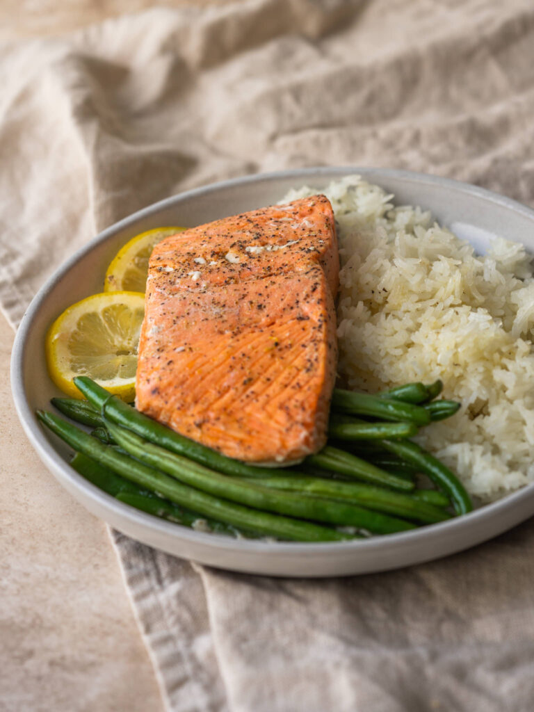 three quarter view of salmon and rice recipe on a plate