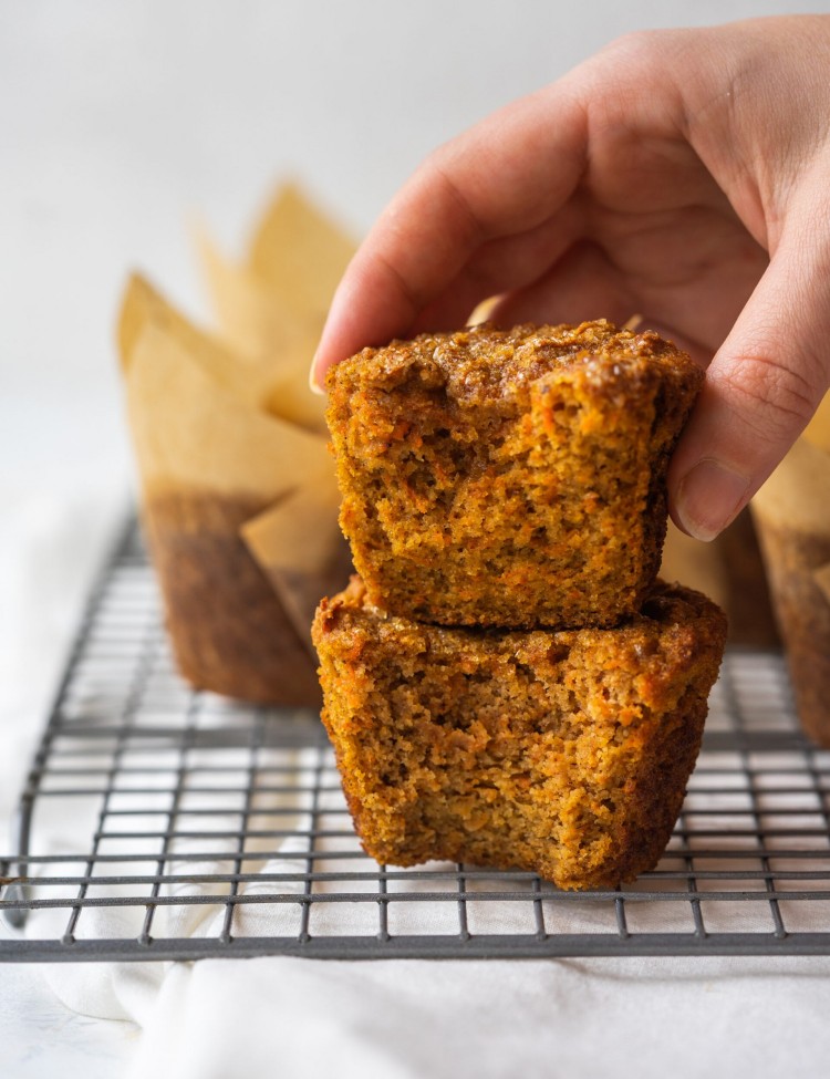 Side view of healthy carrot cake muffins with a bite out of them