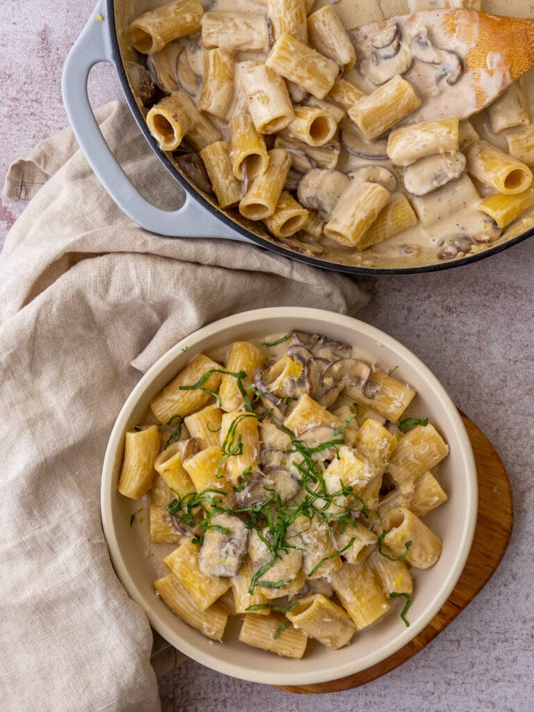 Above view of pasta with mushroom alfredo sauce in a serving bowl