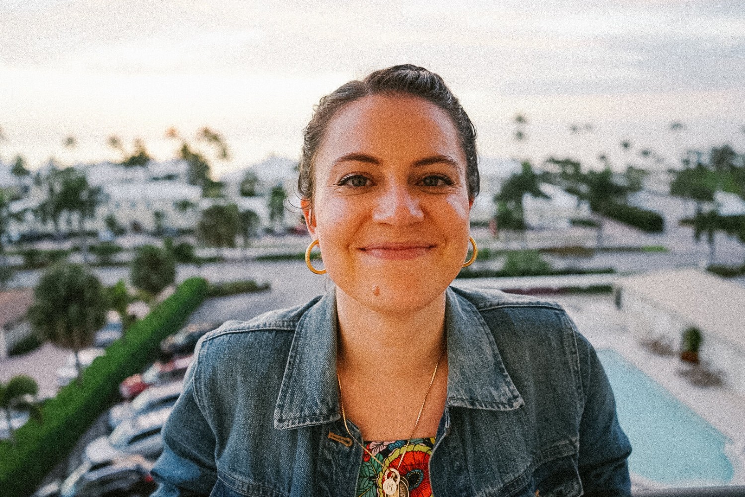 Photo of my in 2019 on a balcony overlooking the ocean smiling