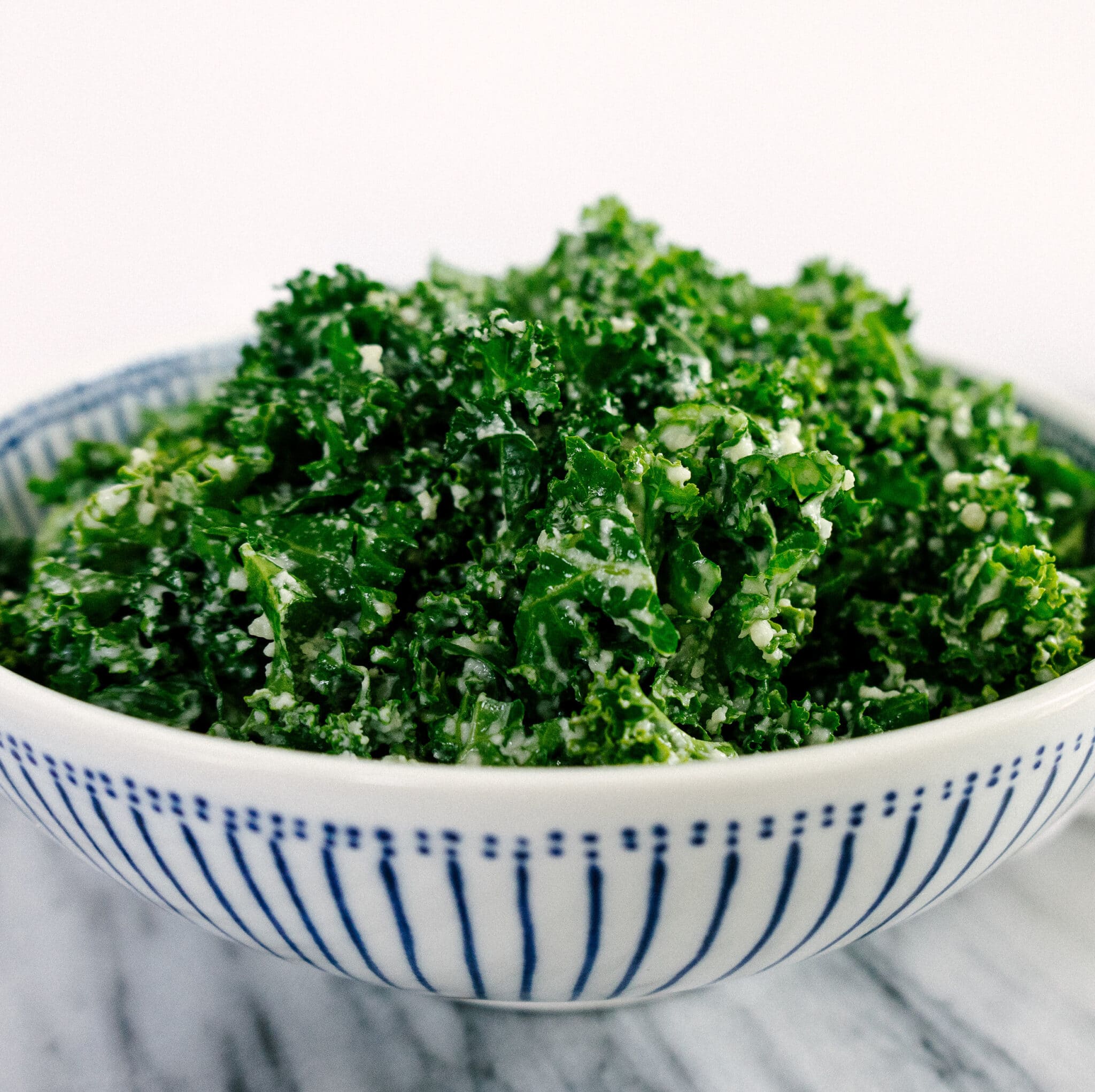 Side view of the best kale salad ever in a serving bowl