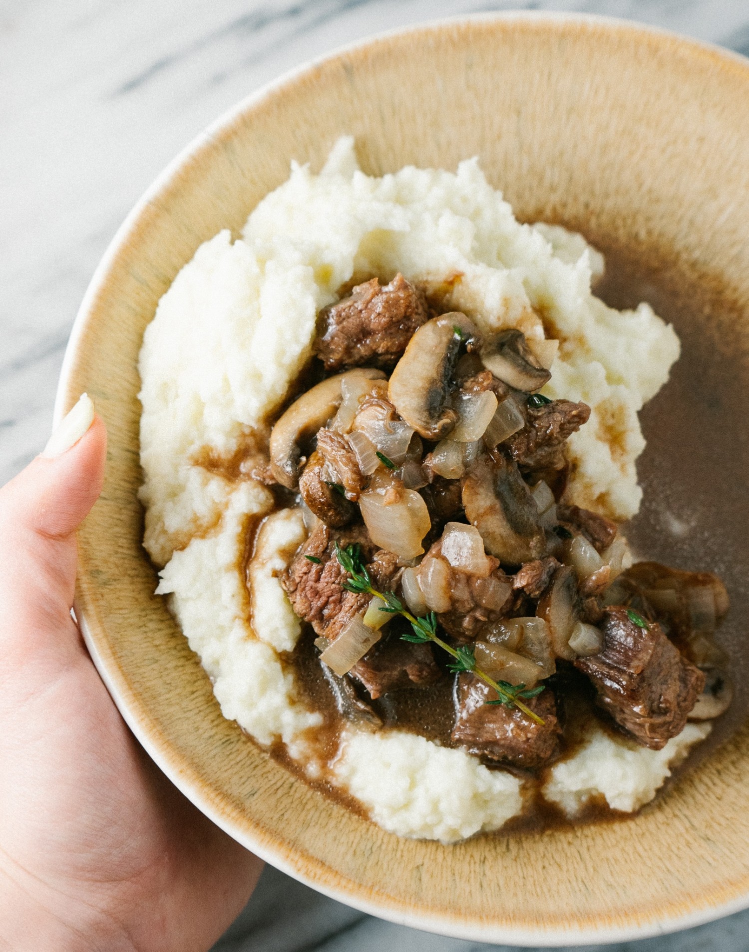 Above view of beef and mushroom recipe over keto cauliflower mash on  a plate