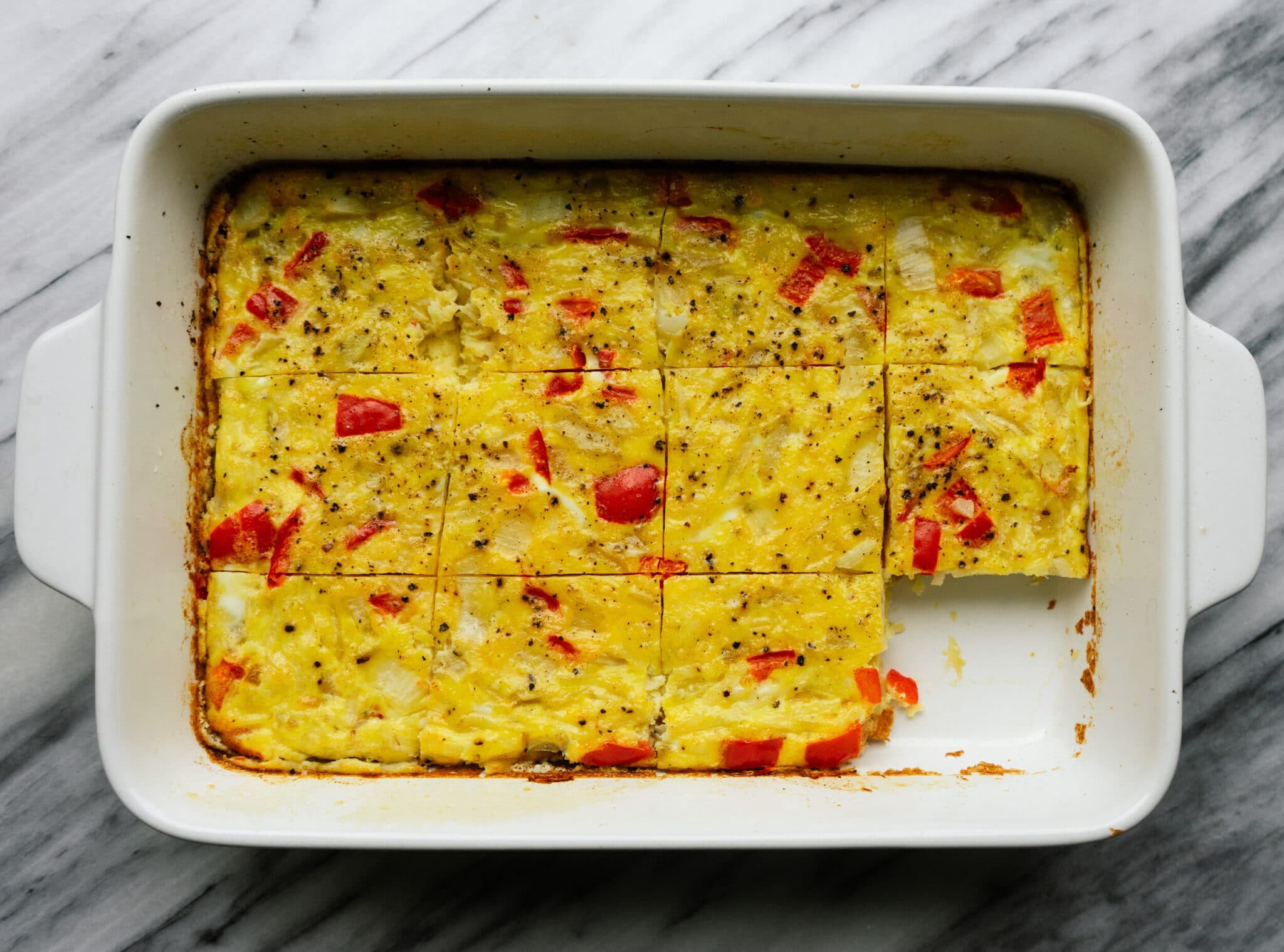Above view of breakfast casserole with hashbrowns in a baking dish