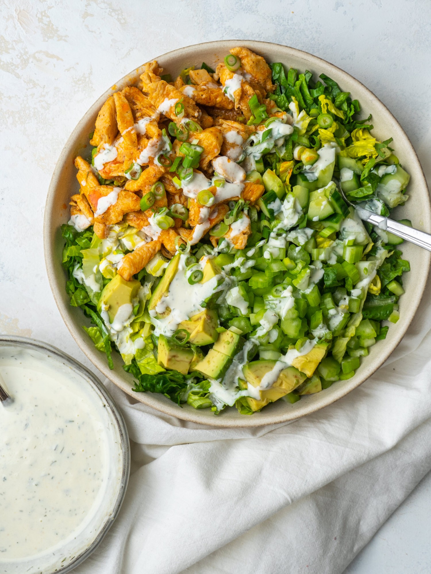 Above view of Buffalo Chicken Salad with a Greek Yogurt Ranch Dressing drizzled over top
