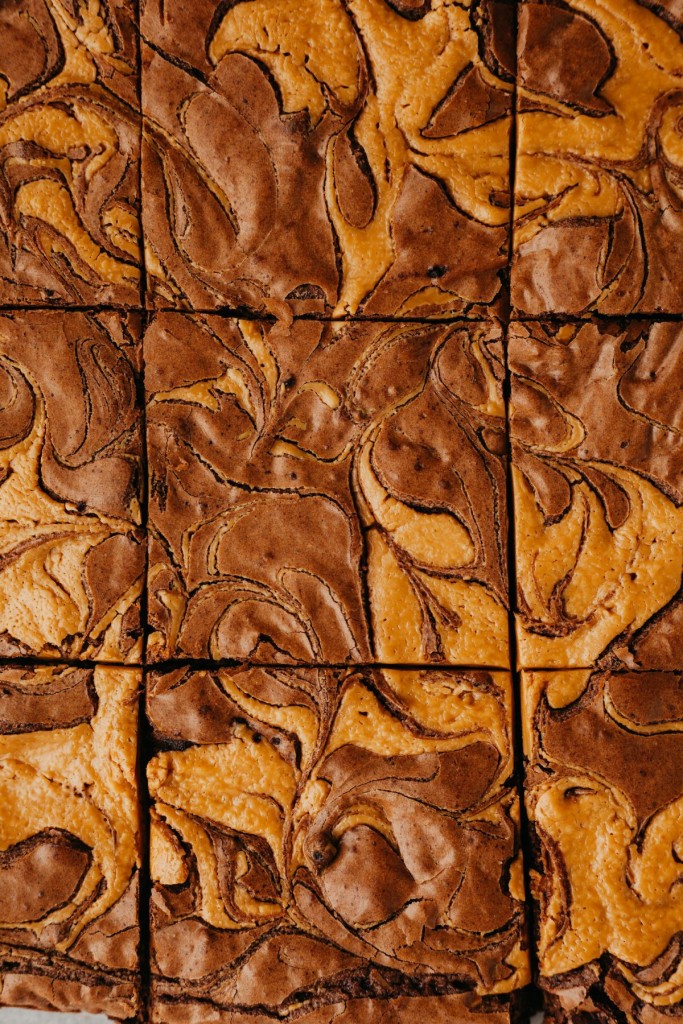 Above view of flourless peanut butter brownies in a pan cut into squarews