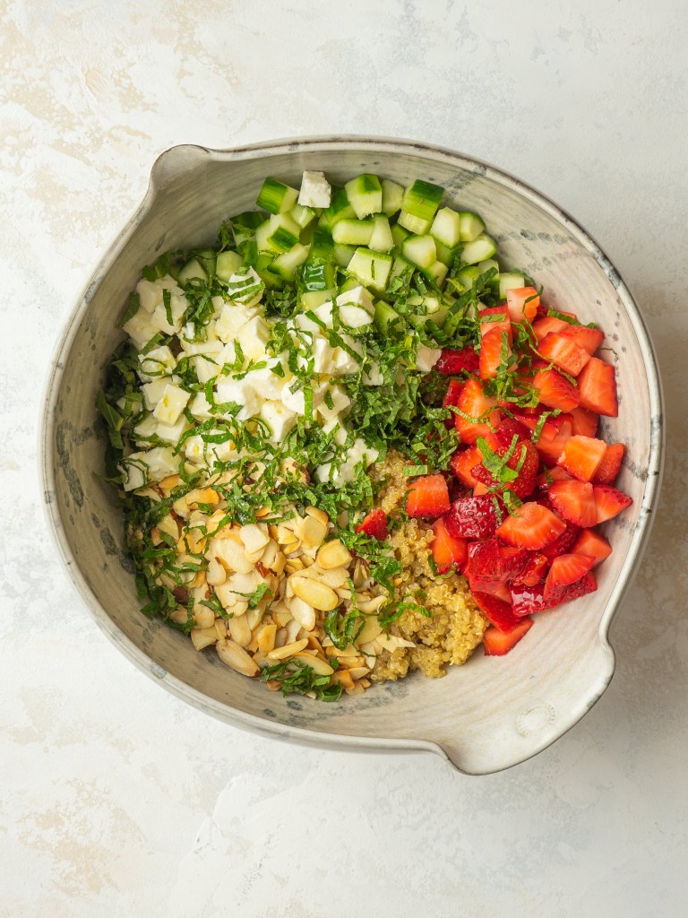 Above view of quinoa salad recipe ingredients in a mixing bowl