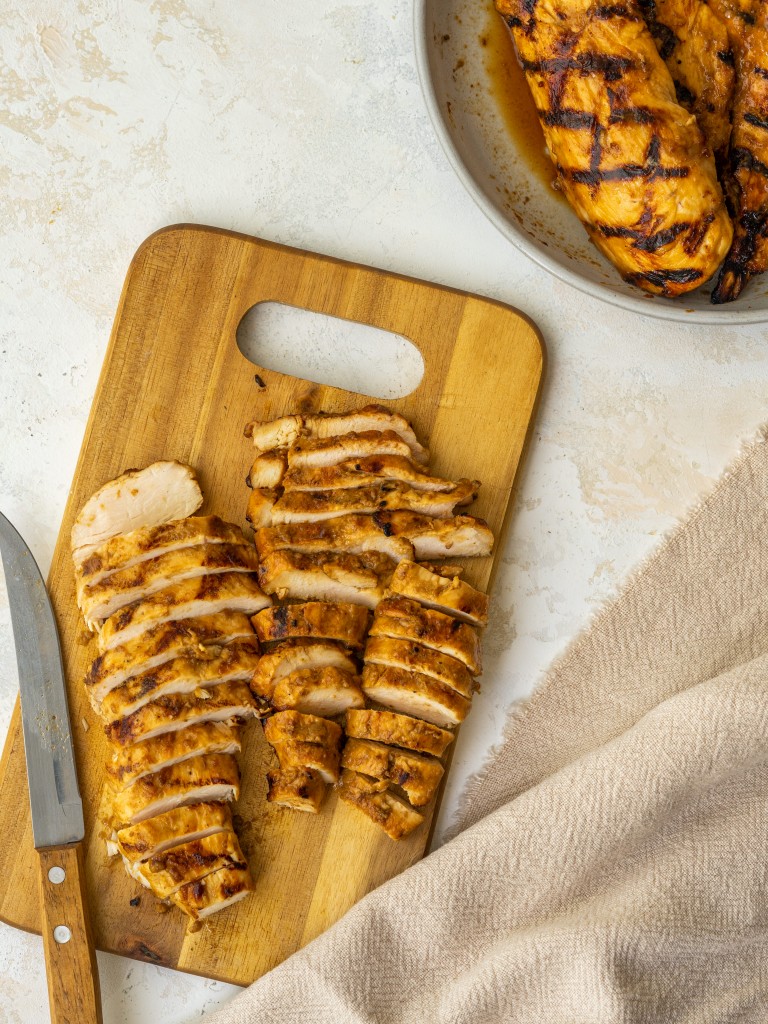 Above view of sliced balsamic grilled chicken on a cutting board