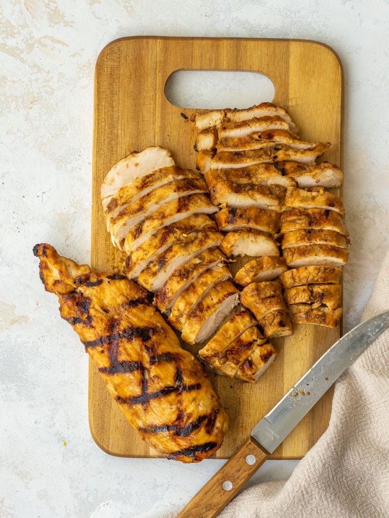 Above view of sliced balsamic chicken on a cutting board