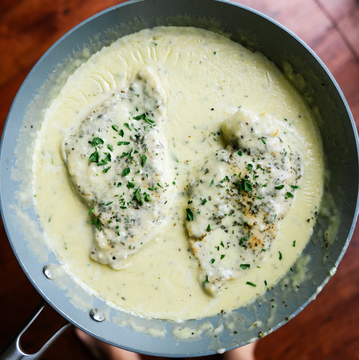 Above view of keto one pot chicken alfredo in a frying pan with alfredo